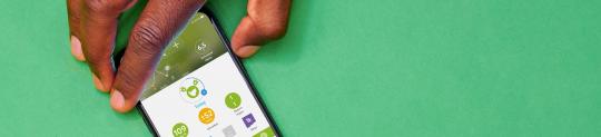 Hand holding smart phone displaying mySugr app
