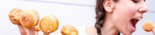 women eating small cakes
